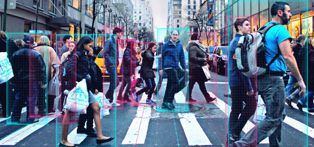 Pedestrian-detection technology in action at a busy downtown intersection crosswalk.