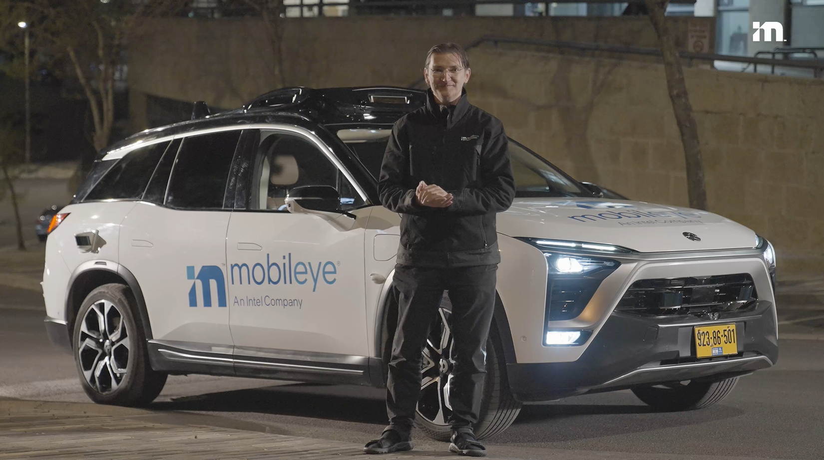 Johann "JJ" Jungwirth next to a Mobileye robotaxi at night in Jerusalem