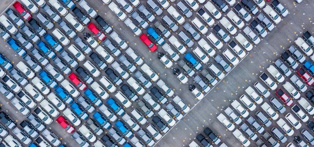 Parking lot filled with new cars and trucks