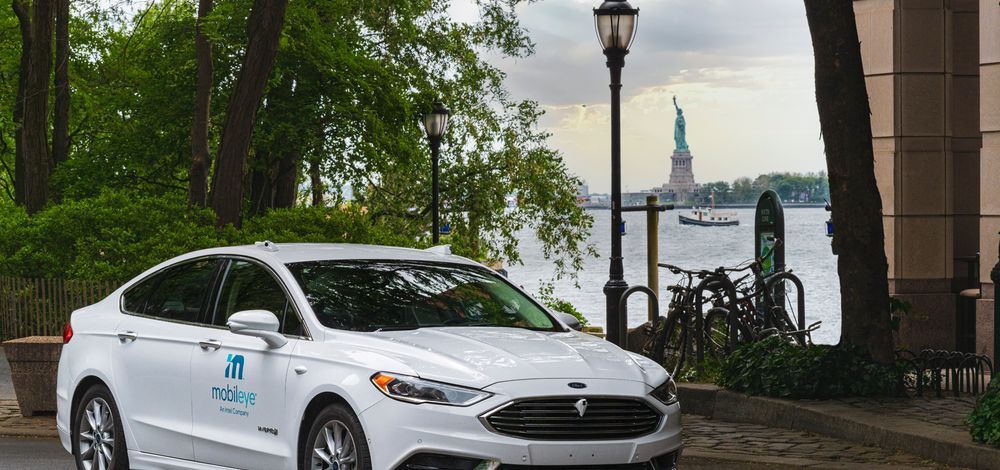 A self-driving vehicle from Mobileye’s autonomous test fleet sits parked across from the Statue of Liberty in June 2021.