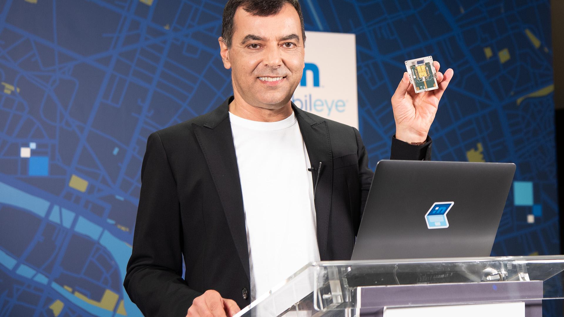 During his annual "Under the Hood" address at the all-virtual CES 2021, Prof. Amnon Shashua, president and CEO of Mobileye, shows off a new silicon photonics lidar SoC that will deliver frequency-modulated continuous wave (FMCW) lidar on a chip for autonomous vehicles beginning in 2025. (Credit: Intel Corporation)